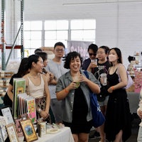 a group of people standing around a table