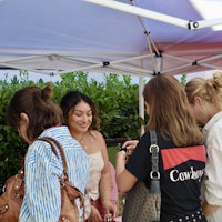 a group of people standing under a tent